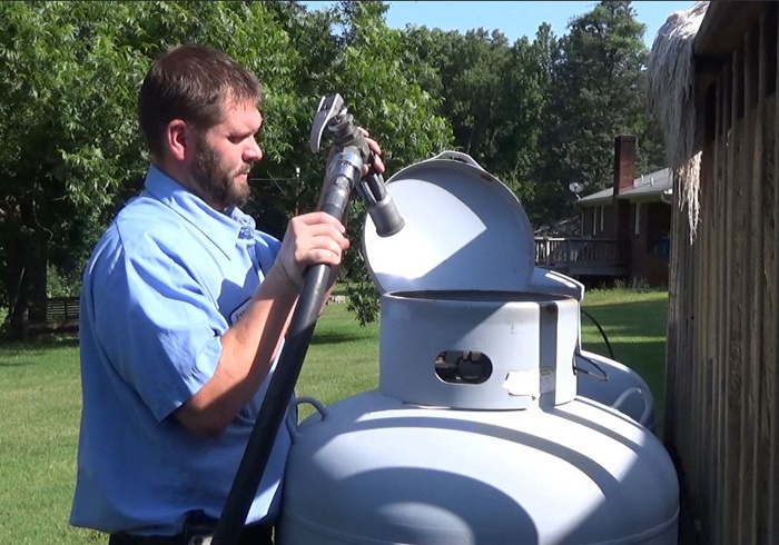 Photo of driver refueling a customer's propane tank