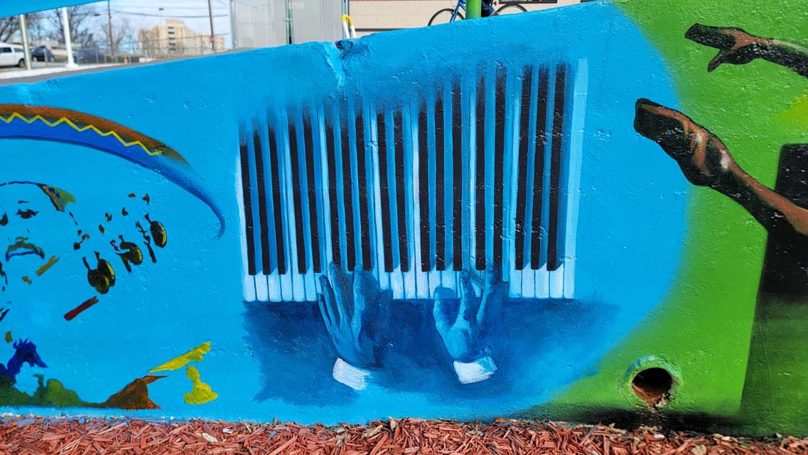 Mural painting of hands playing piano