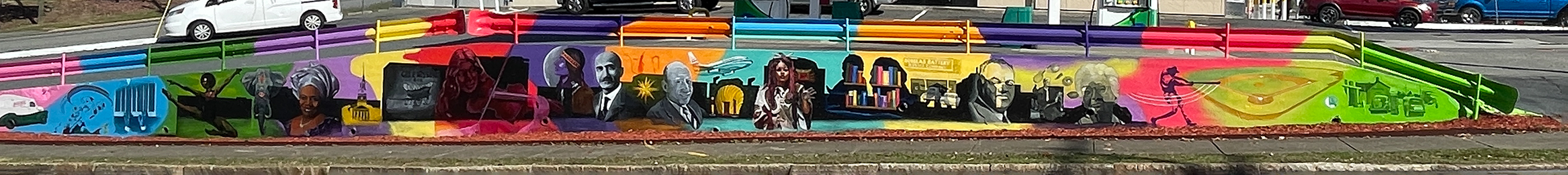 A photo of the mural at the Quality Mart on the corner of Broad and 5th street, featuring many figures and cultural elements. Painted by Leo Rucker.